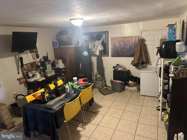 a room with gym equipment and a flat screen tv