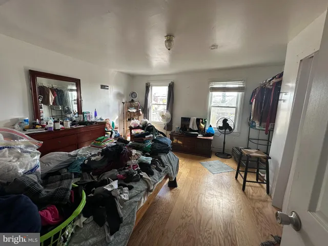 a living room with lots of furniture and a wooden floor
