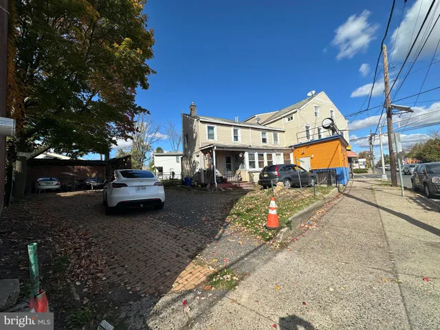 a wooden bench sitting in front of a building