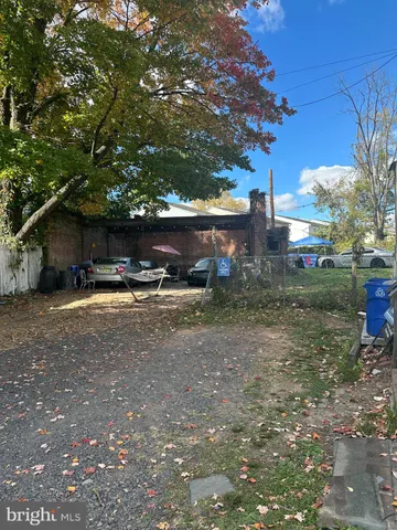 a view of a house with a yard and tree s