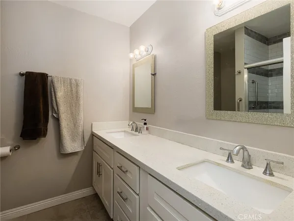 a bathroom with a double vanity sink and a mirror