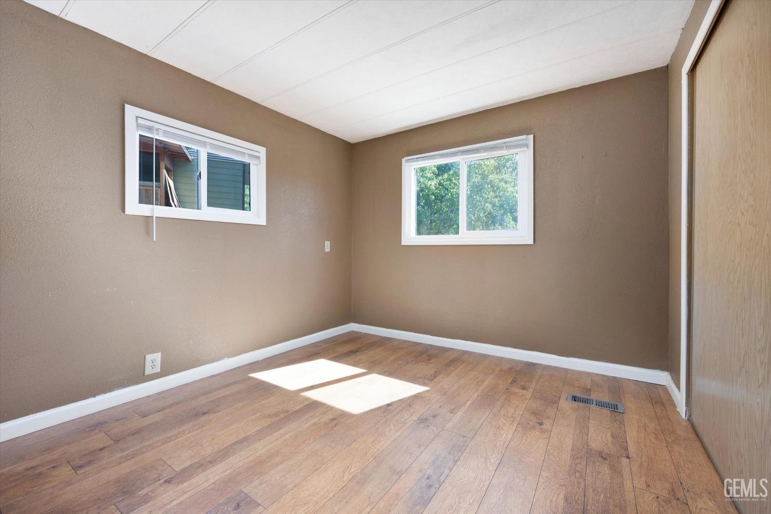 Undisclosed Address Pine Mountain Club, CA 93222 - Photo 19 of 22 a view of a big room with wooden floor and windows