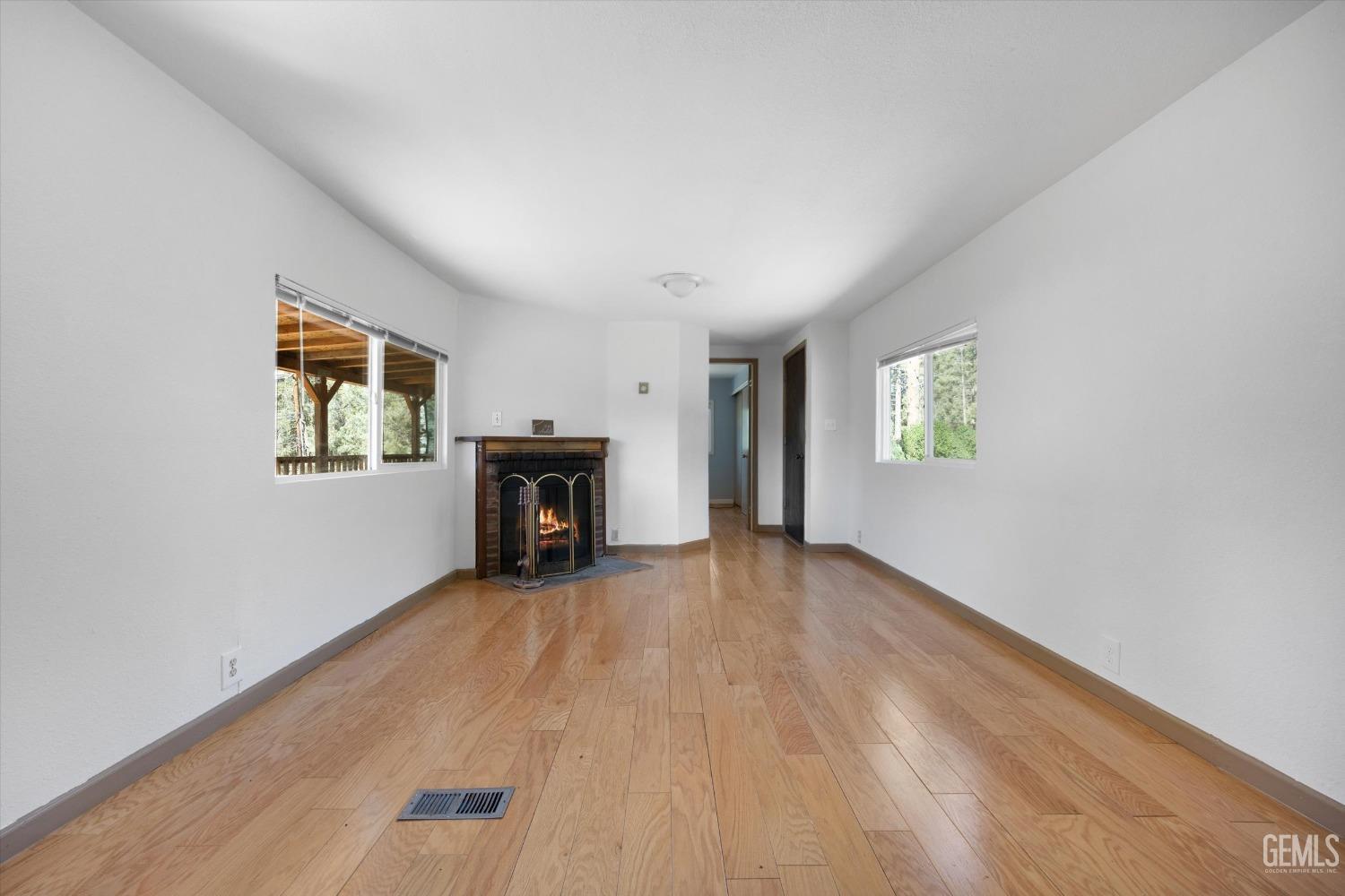 Undisclosed Address Pine Mountain Club, CA 93222 - Photo 5 of 22 an empty room with windows and fireplace