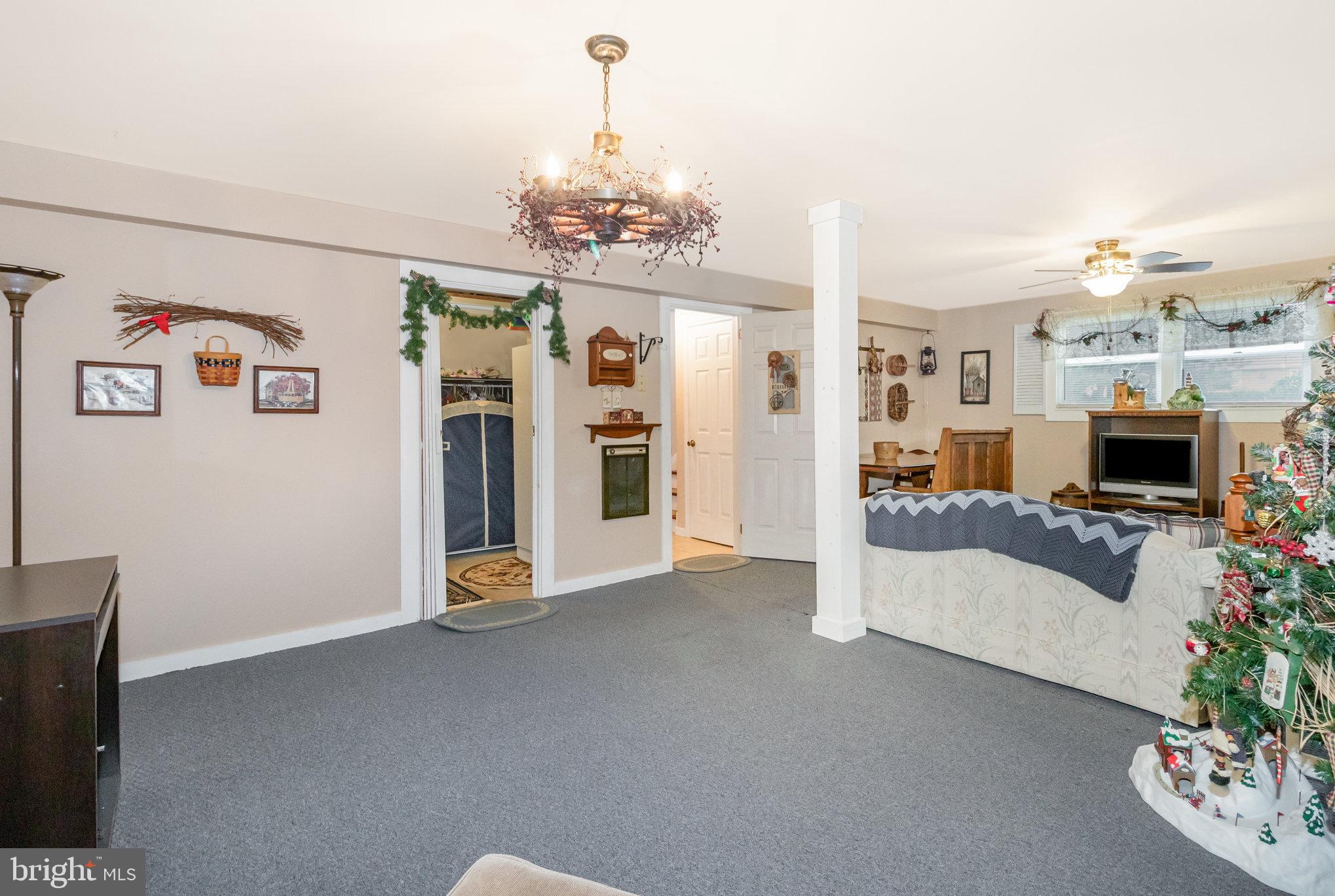 21 Cardinal Drive Carlisle, PA 17015 - Photo 20 of 33 a living room with furniture and a chandelier