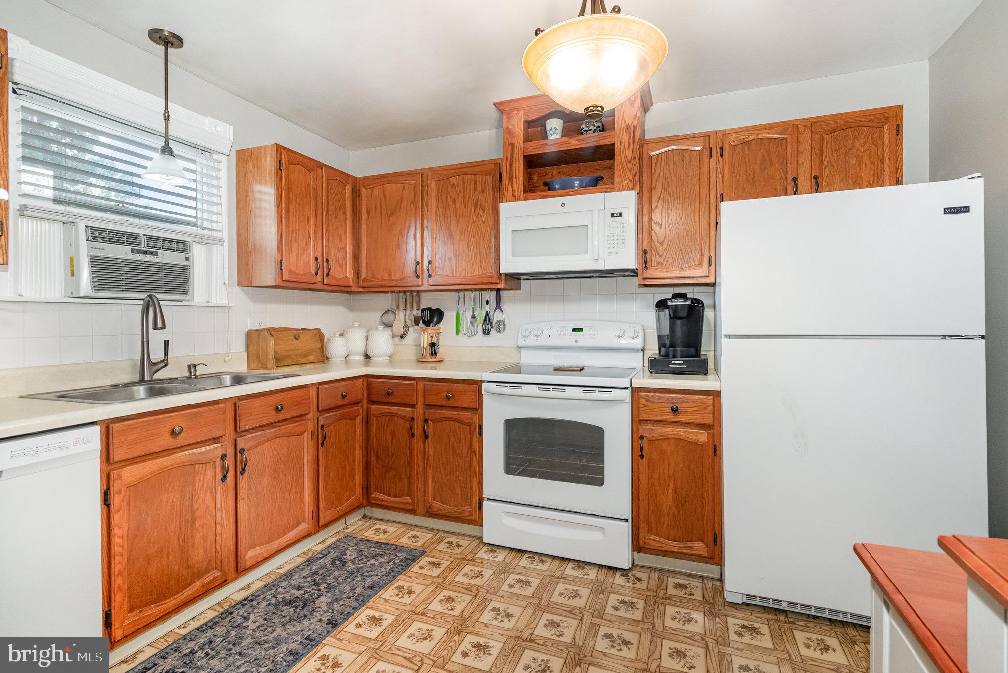 21 Cardinal Drive Carlisle, PA 17015 - Photo 6 of 33 a kitchen with a sink a stove a refrigerator and cabinets