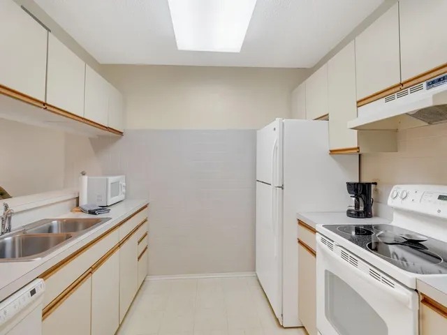 a kitchen with a sink a stove and refrigerator