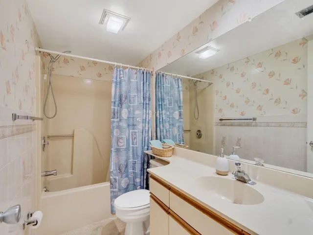 a bathroom with a sink toilet tub and shower