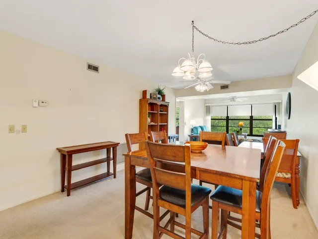 a dining room with furniture a chandelier and a rug