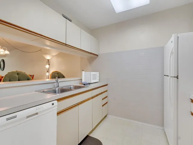 a kitchen with a sink and a refrigerator