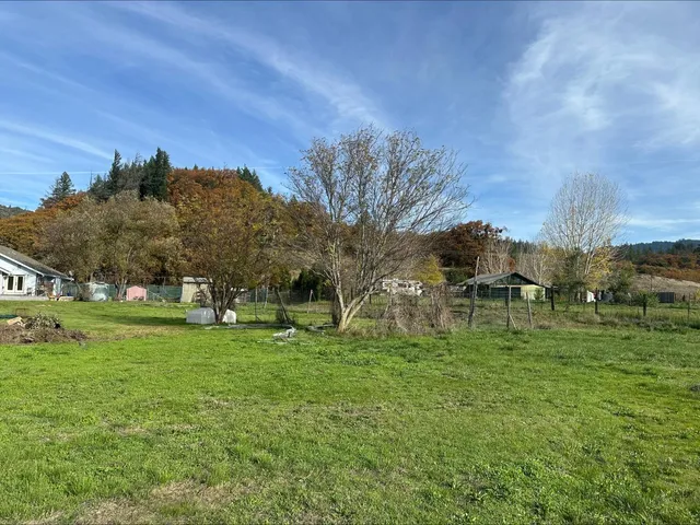 a backyard of apartments with large trees