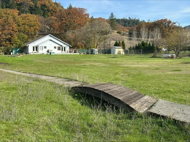 a view of a house with a yard and front view of a house