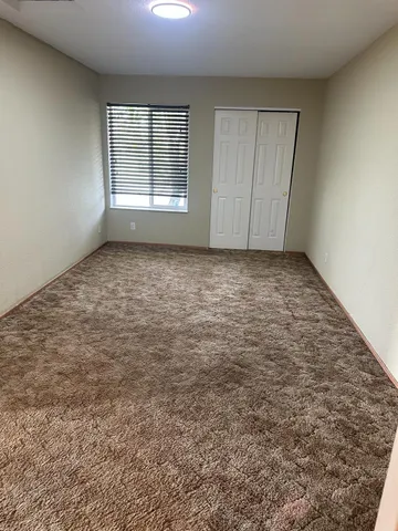 an empty room with a empty space and windows