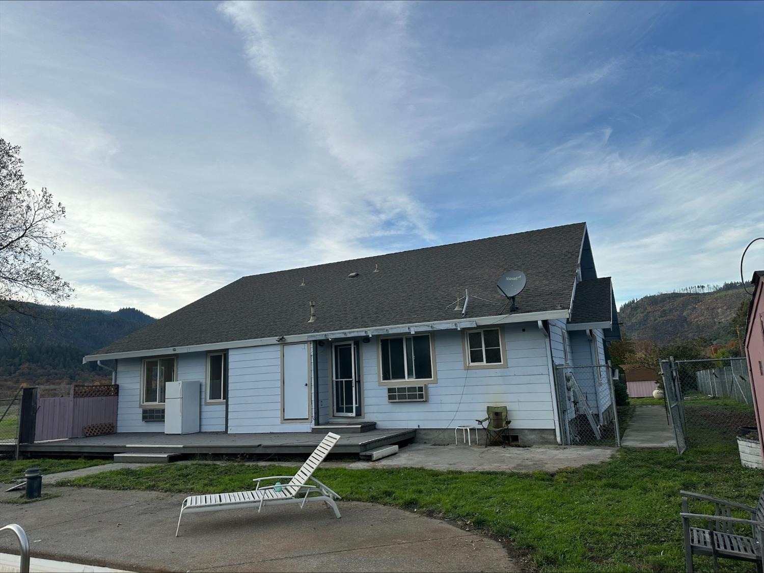 581 Garrett Road Hyampom, CA 96046 - Photo 3 of 45 a front view of a house with a yard and garage