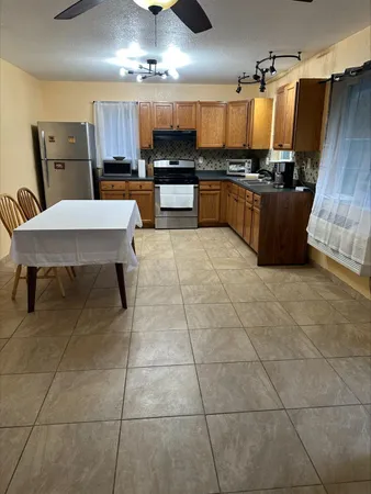 a kitchen with a cabinets a counter space a sink and appliances