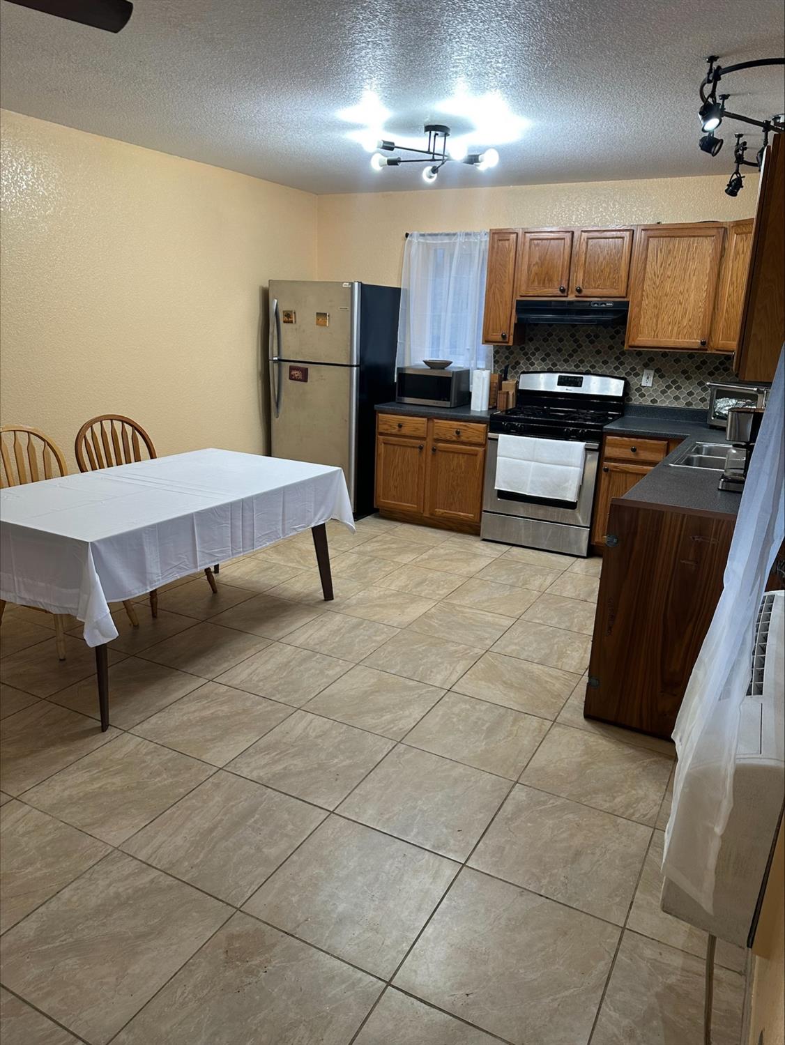 581 Garrett Road Hyampom, CA 96046 - Photo 34 of 45 a kitchen with stainless steel appliances a stove a sink and a refrigerator