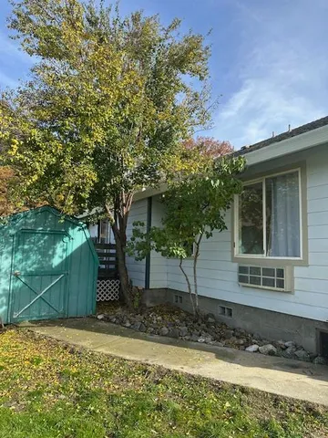 a view of a house with a tree