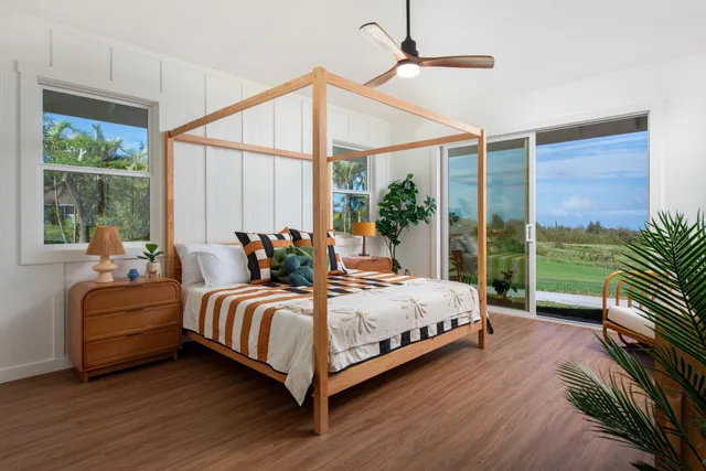 a bedroom with a bed and a large window