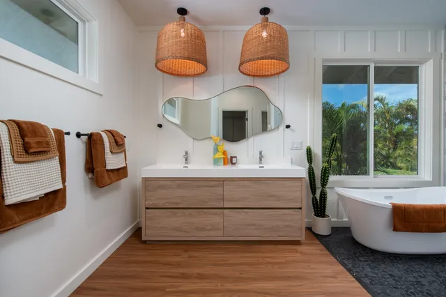 a bathroom with a tub sink and mirror