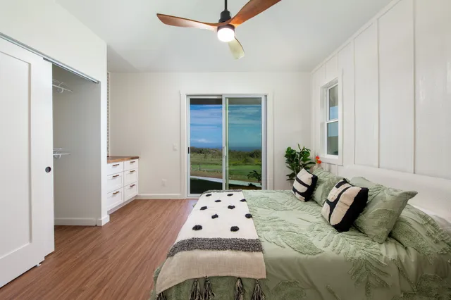 a bedroom with a large bed and a window