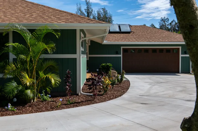 a front view of a house with garden