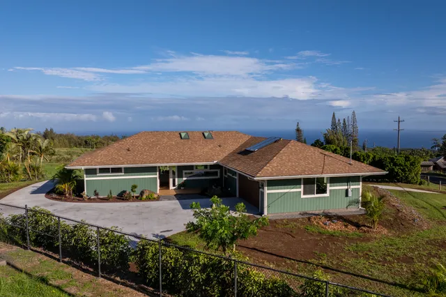 aerial view of house with yard and green space