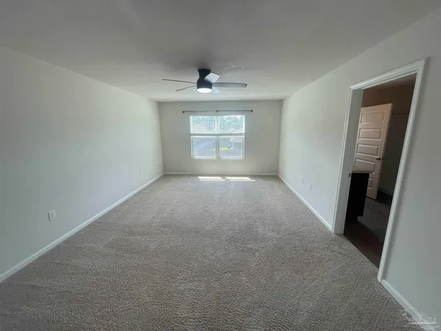 an empty room with windows and cabinet