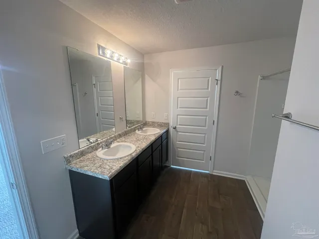a bathroom with a granite countertop sink and a mirror