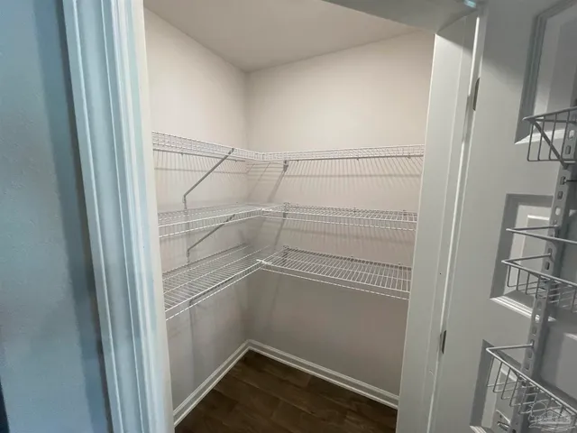 a view of storage and utility room with a fireplace