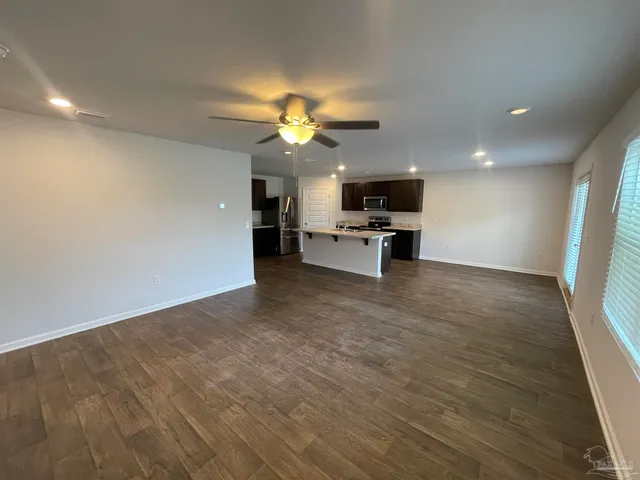 a view of living room with furniture and a ceiling fan