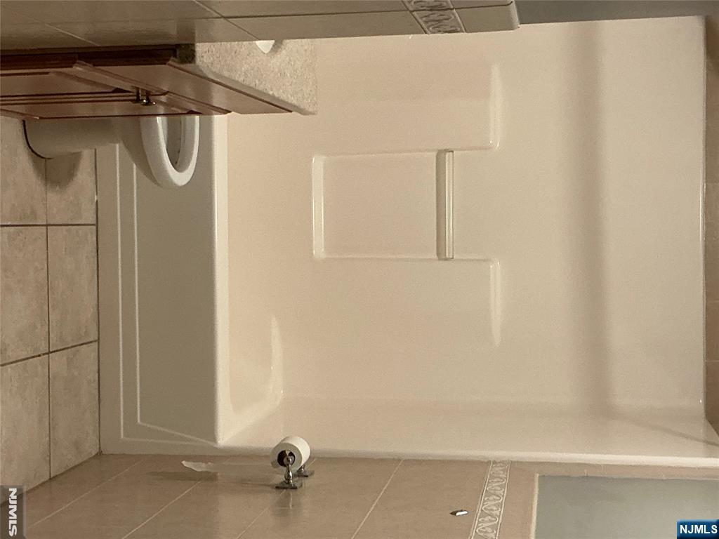 102 Berry Street, Unit 5 Hackensack, NJ 07601 - Photo 10 of 13 a bathroom with a bathtub and a toilet