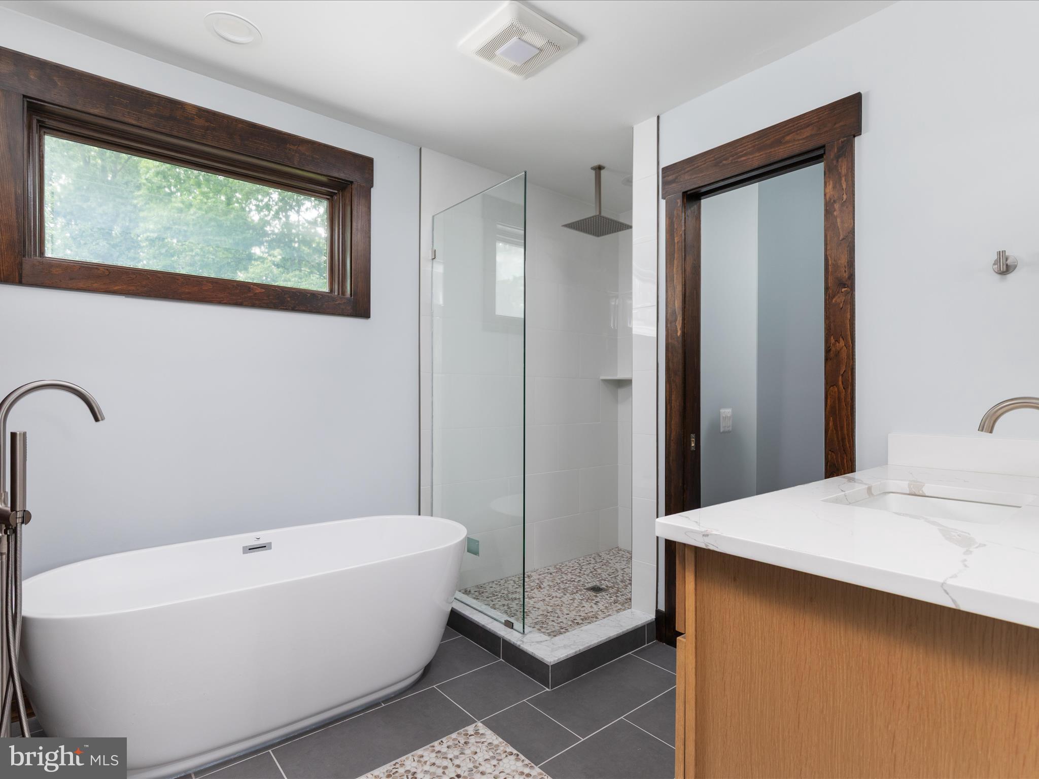 9711 Meadowlark Road Vienna, VA 22182 - Photo 54 of 66 a bathroom with a white tub shower and sink