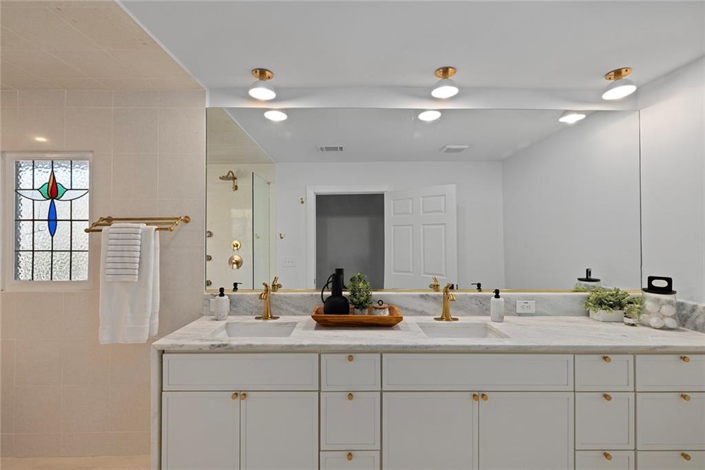 1275 The By Way Northeast Atlanta, GA 30306 - Photo 25 of 50 a bathroom with double sink and a mirror