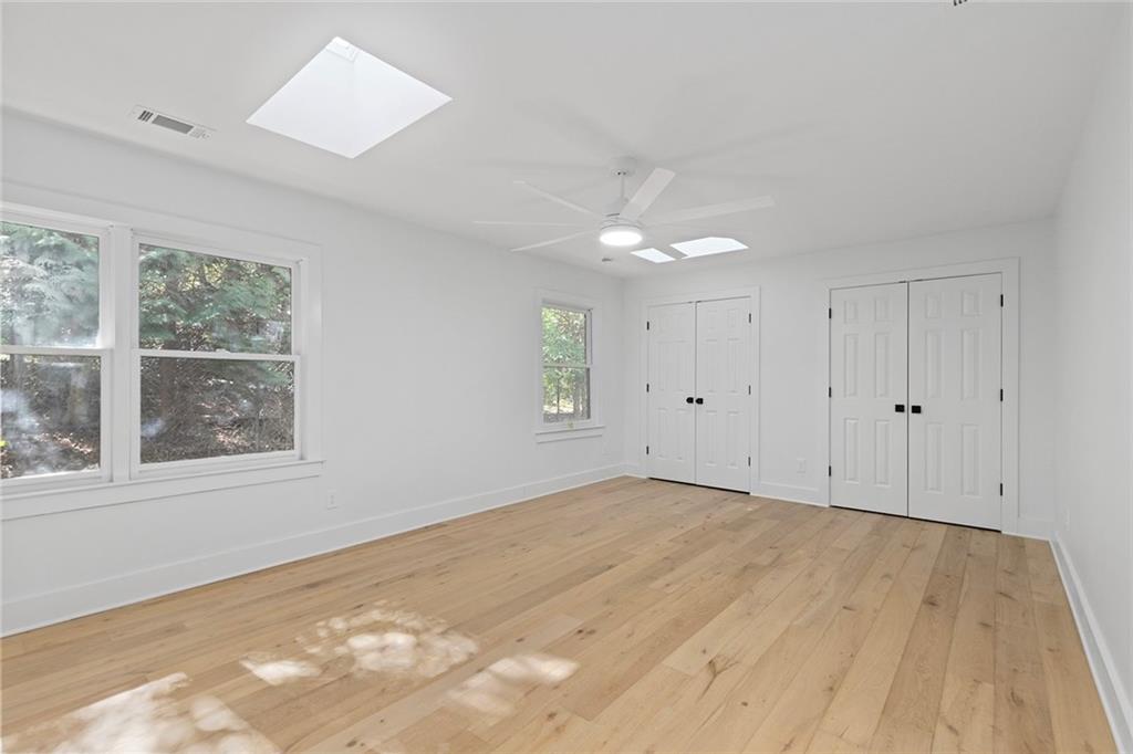 1275 The By Way Northeast Atlanta, GA 30306 - Photo 29 of 50 an empty room with wooden floor and windows