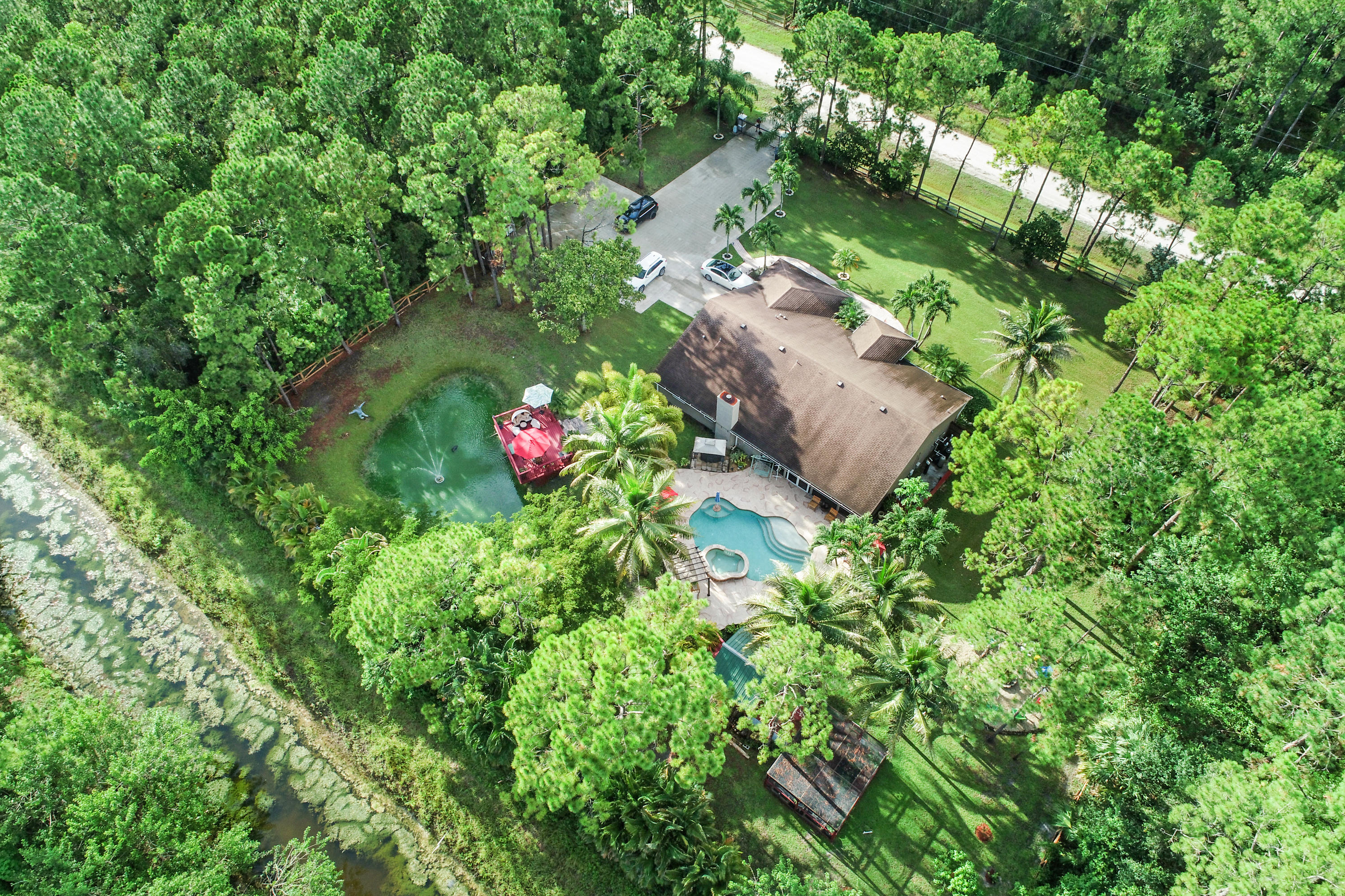 18604 43rd Road North Loxahatchee, FL 33470 - Photo 1 of 40 an aerial view of a house with a yard and lake view