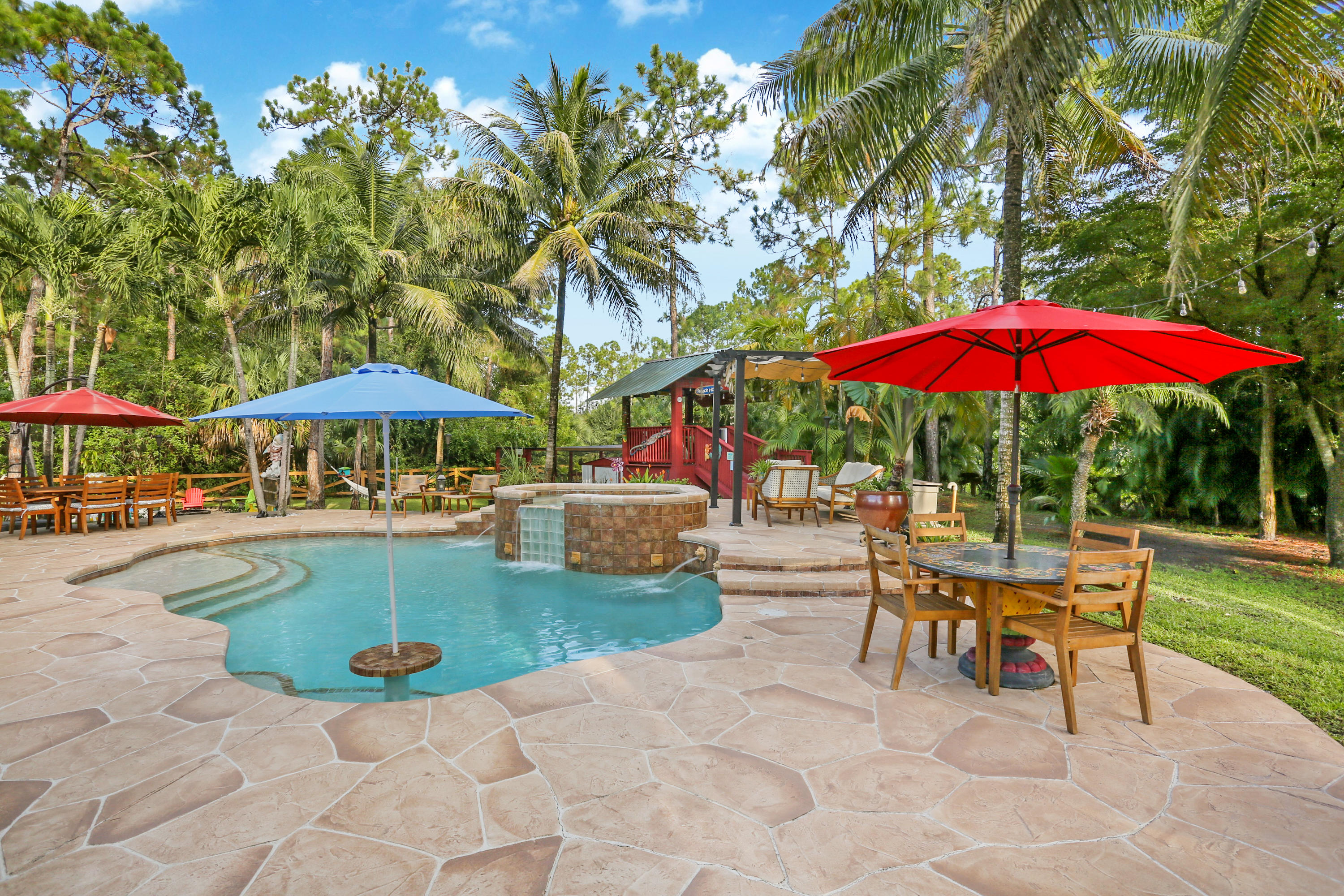18604 43rd Road North Loxahatchee, FL 33470 - Photo 21 of 40 an outdoor space with patio lots of furniture and umbrella