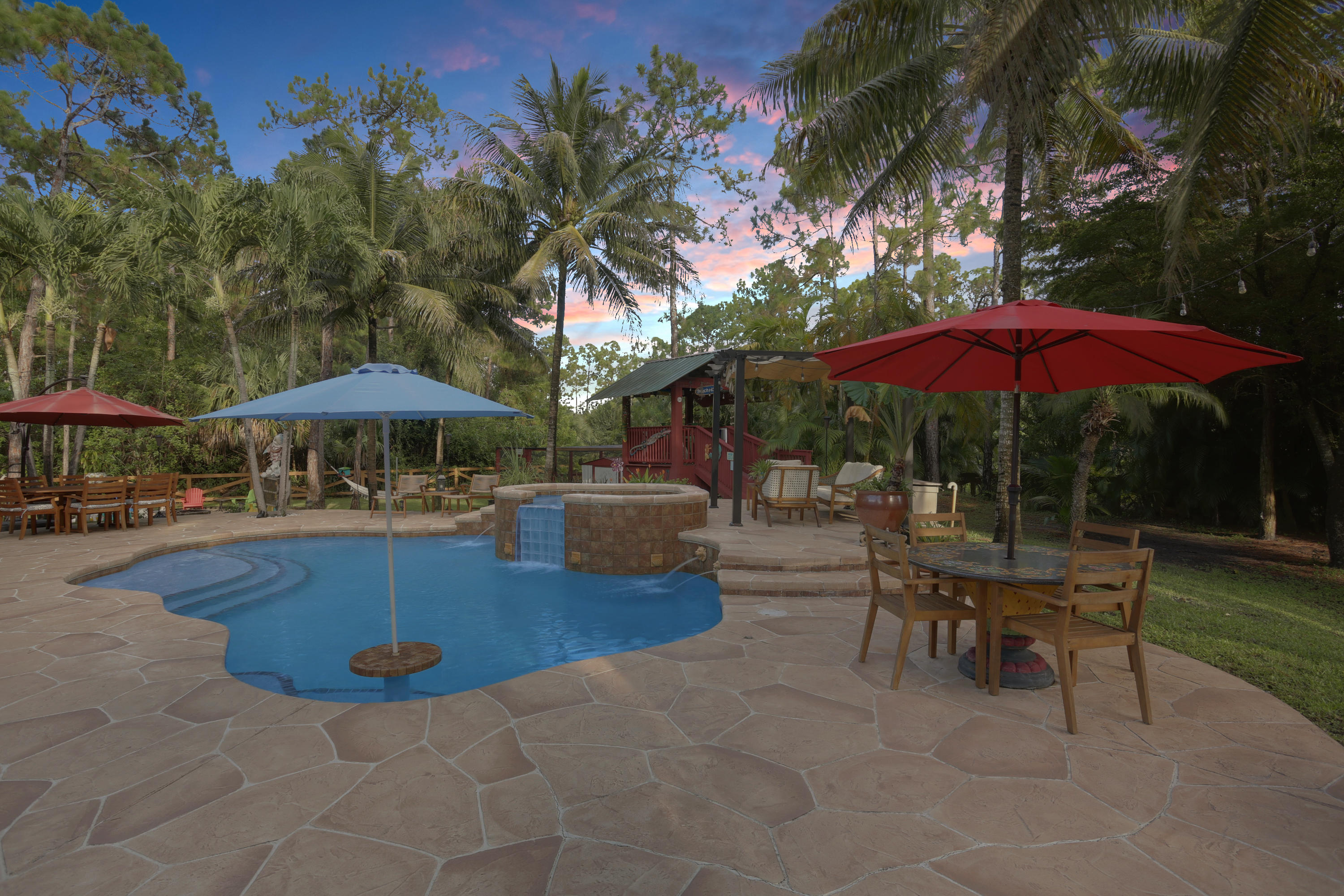 18604 43rd Road North Loxahatchee, FL 33470 - Photo 22 of 40 a view of patio with chairs and table under an umbrella