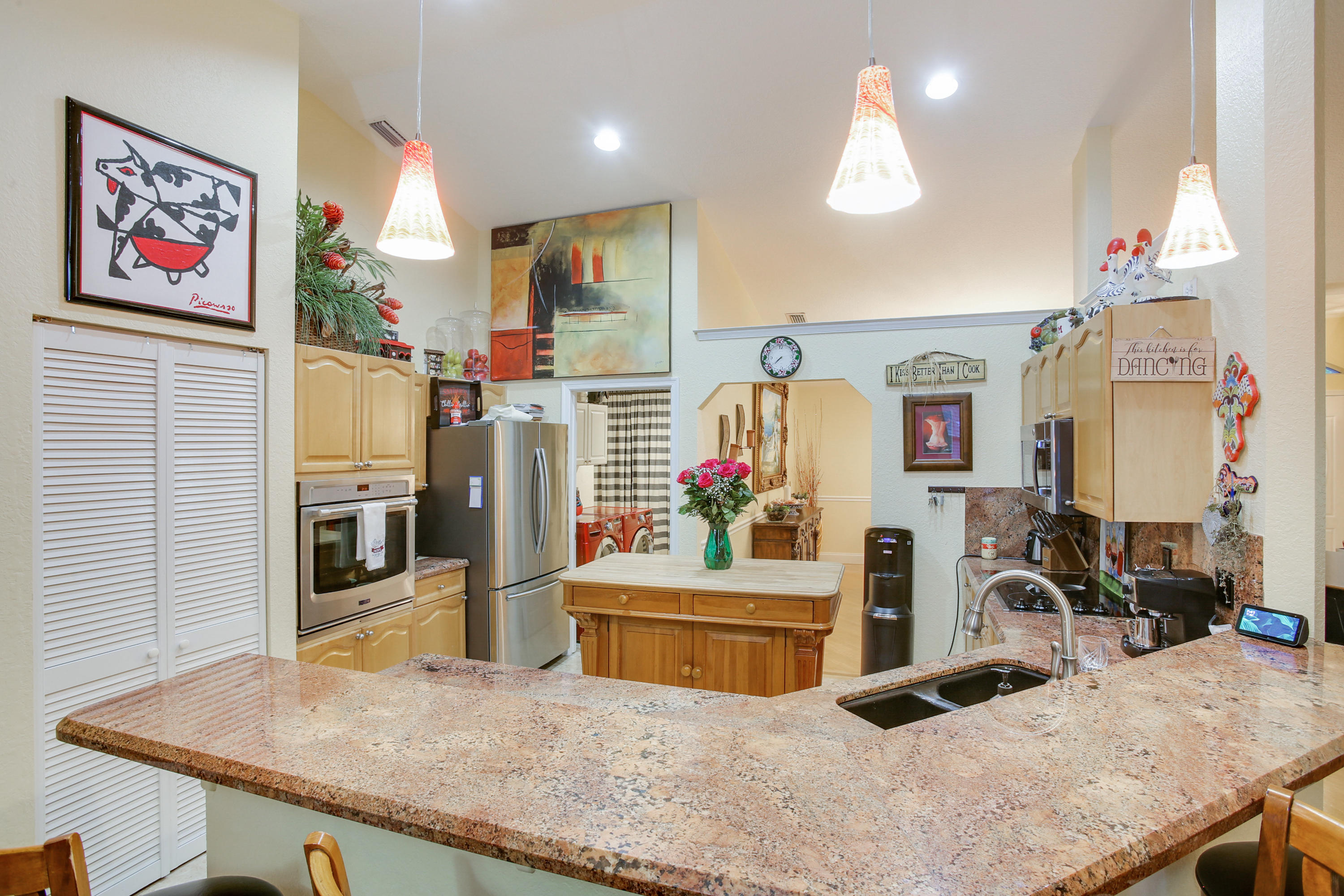 18604 43rd Road North Loxahatchee, FL 33470 - Photo 32 of 40 a kitchen view of counter top space with stainless steel appliances wooden floor and living room view