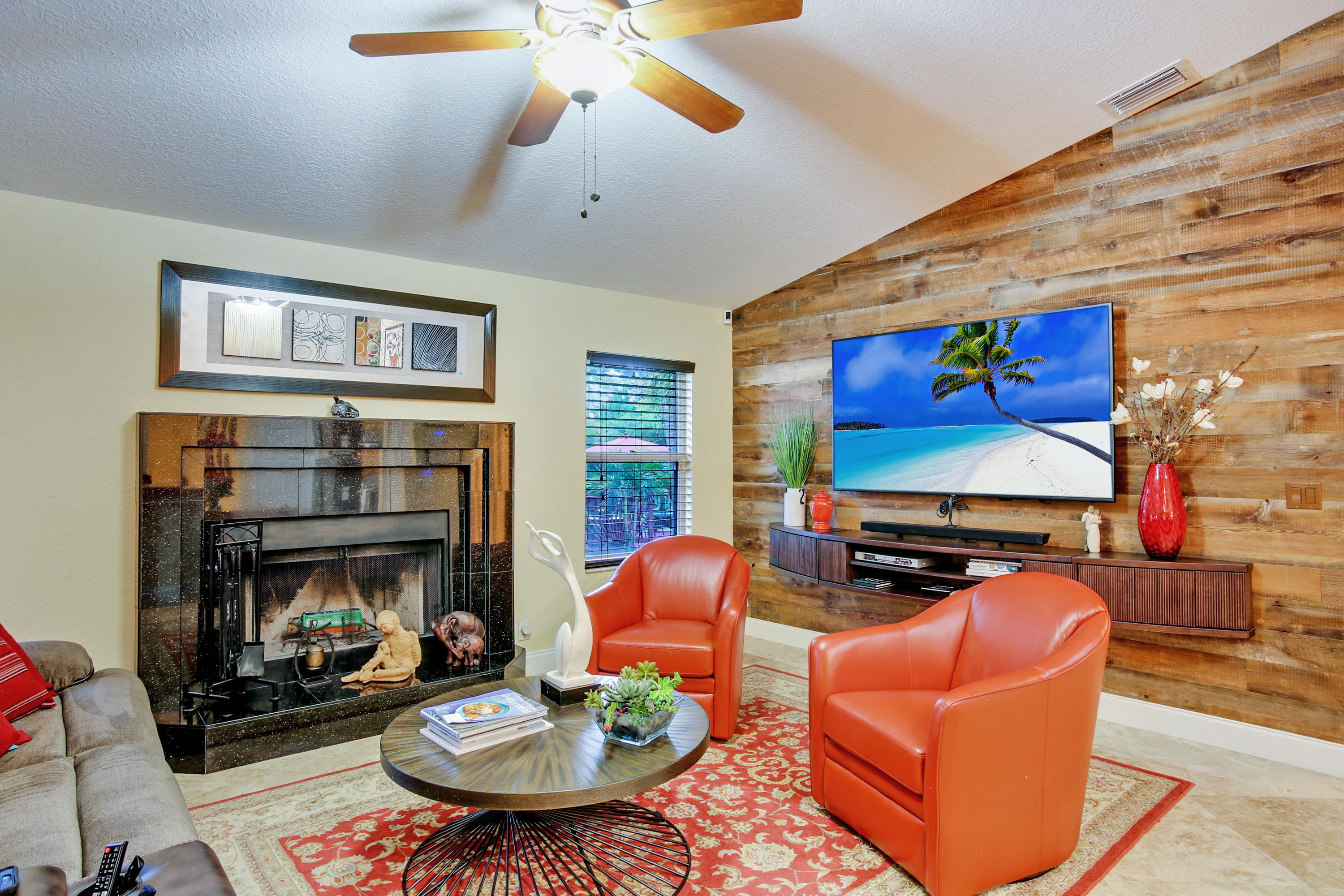 18604 43rd Road North Loxahatchee, FL 33470 - Photo 33 of 40 a living room with furniture a fireplace and a flat screen tv