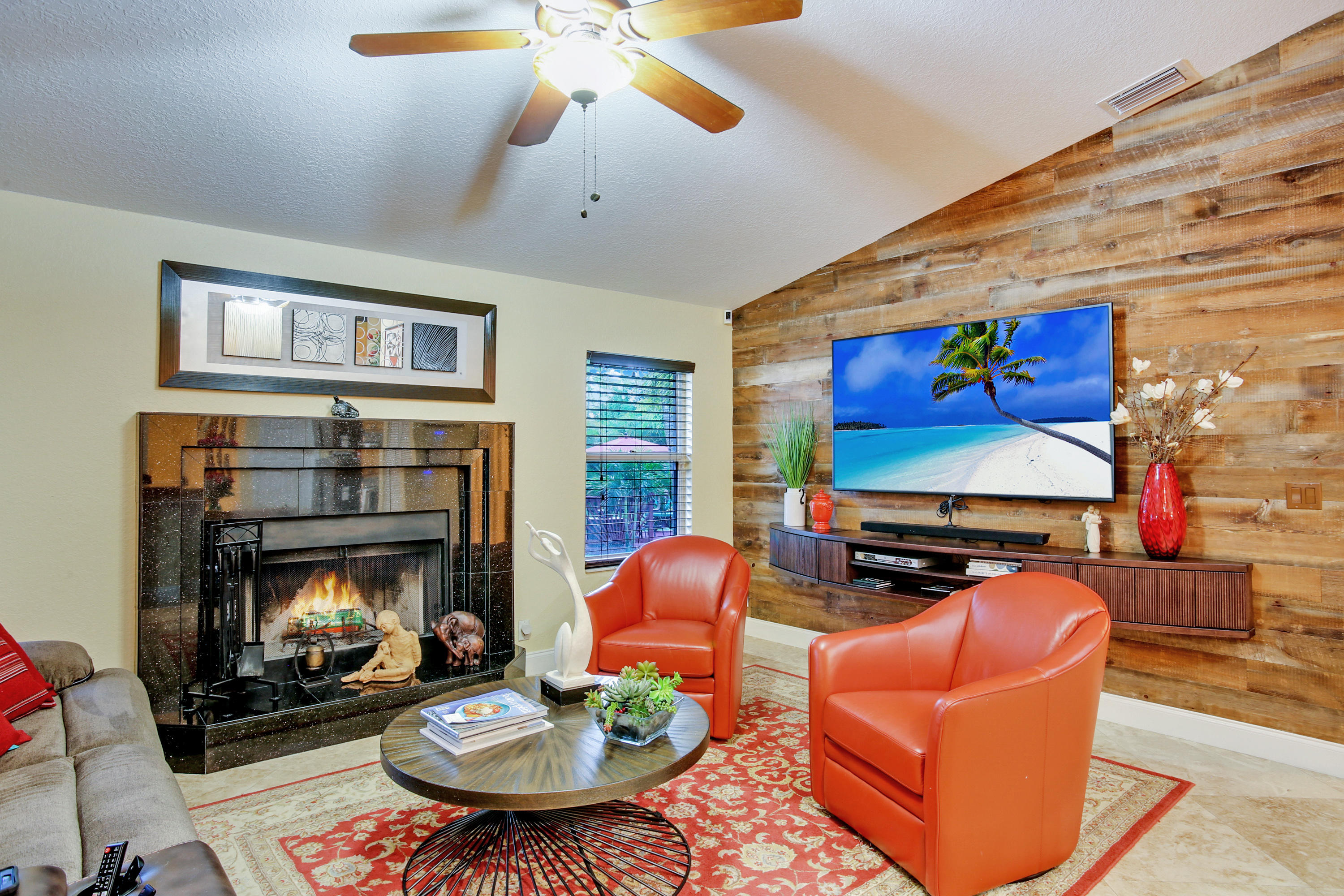 18604 43rd Road North Loxahatchee, FL 33470 - Photo 34 of 40 a living room with furniture a fireplace and a flat screen tv