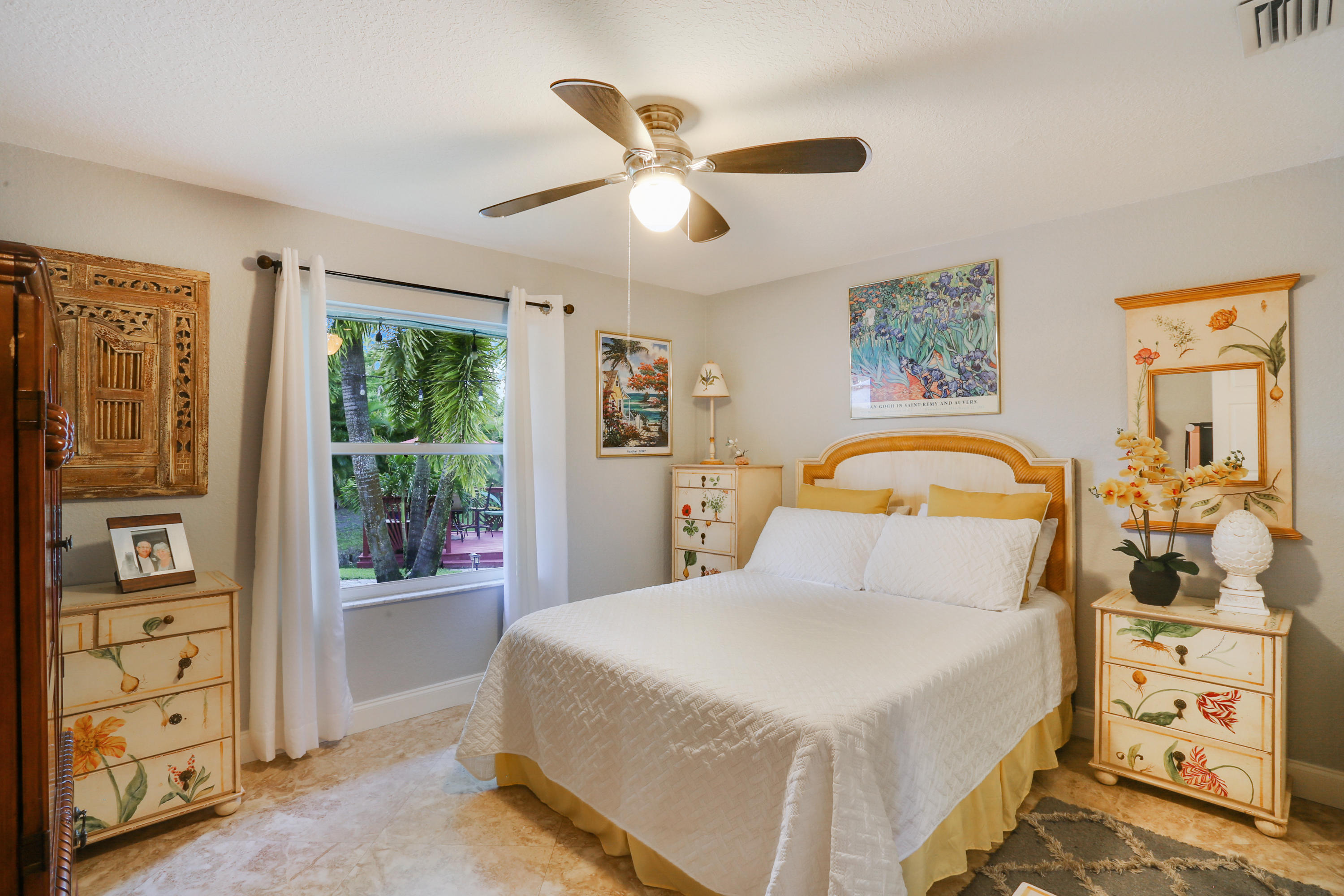 18604 43rd Road North Loxahatchee, FL 33470 - Photo 35 of 40 a bedroom with a large bed and a chandelier