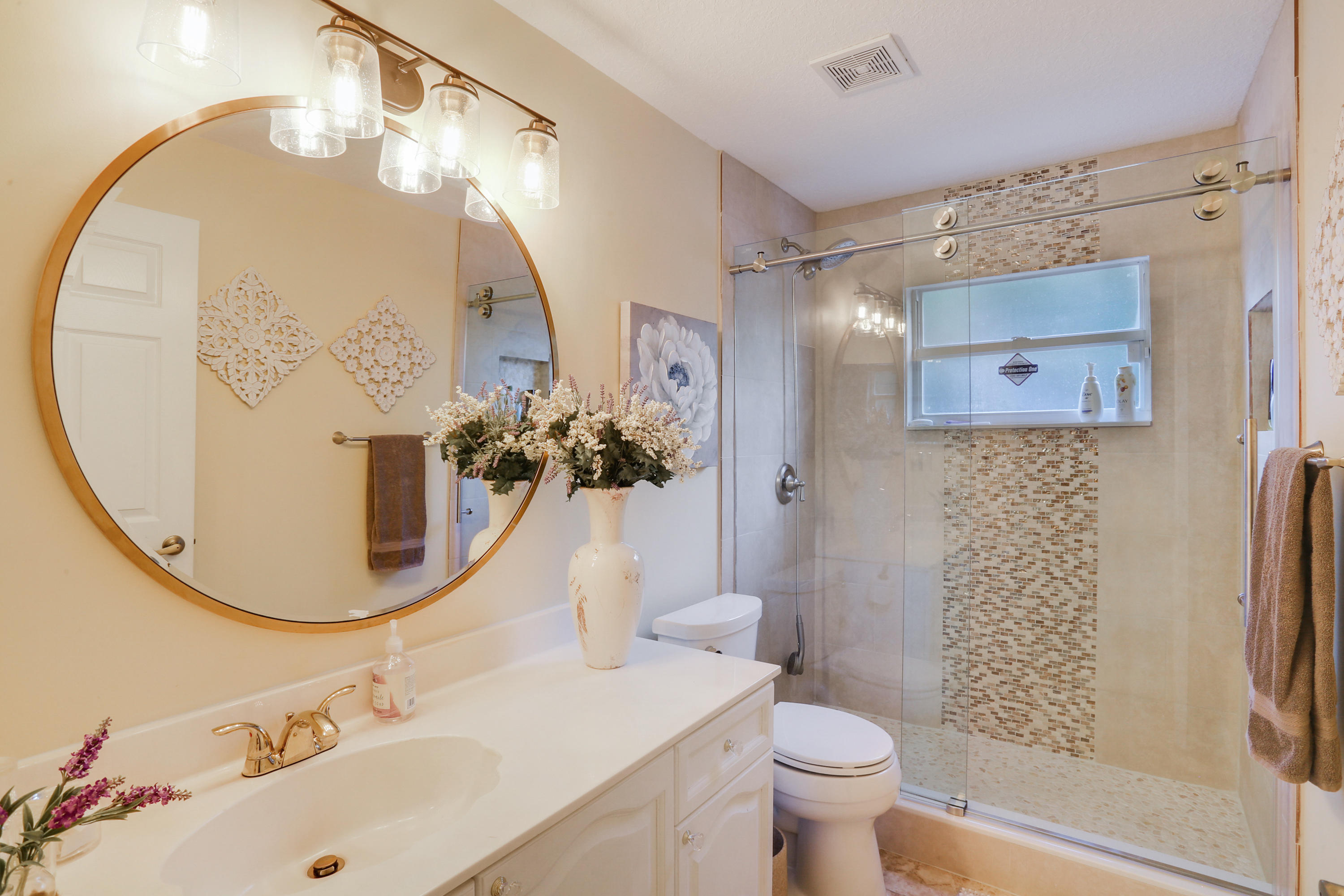 18604 43rd Road North Loxahatchee, FL 33470 - Photo 36 of 40 a bathroom with a sink mirror and toilet