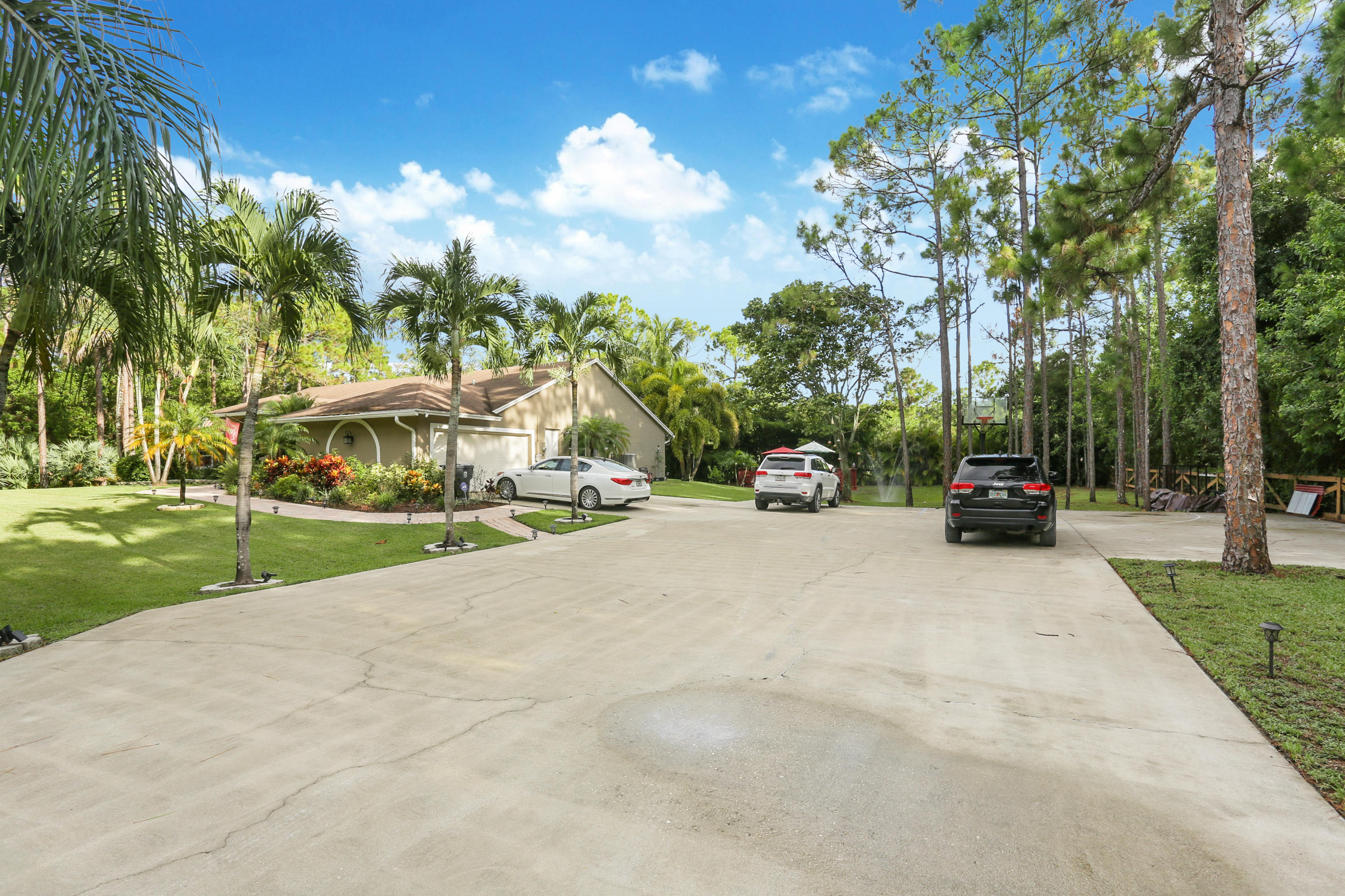 18604 43rd Road North Loxahatchee, FL 33470 - Photo 5 of 40 a view of car parked on the side of a road