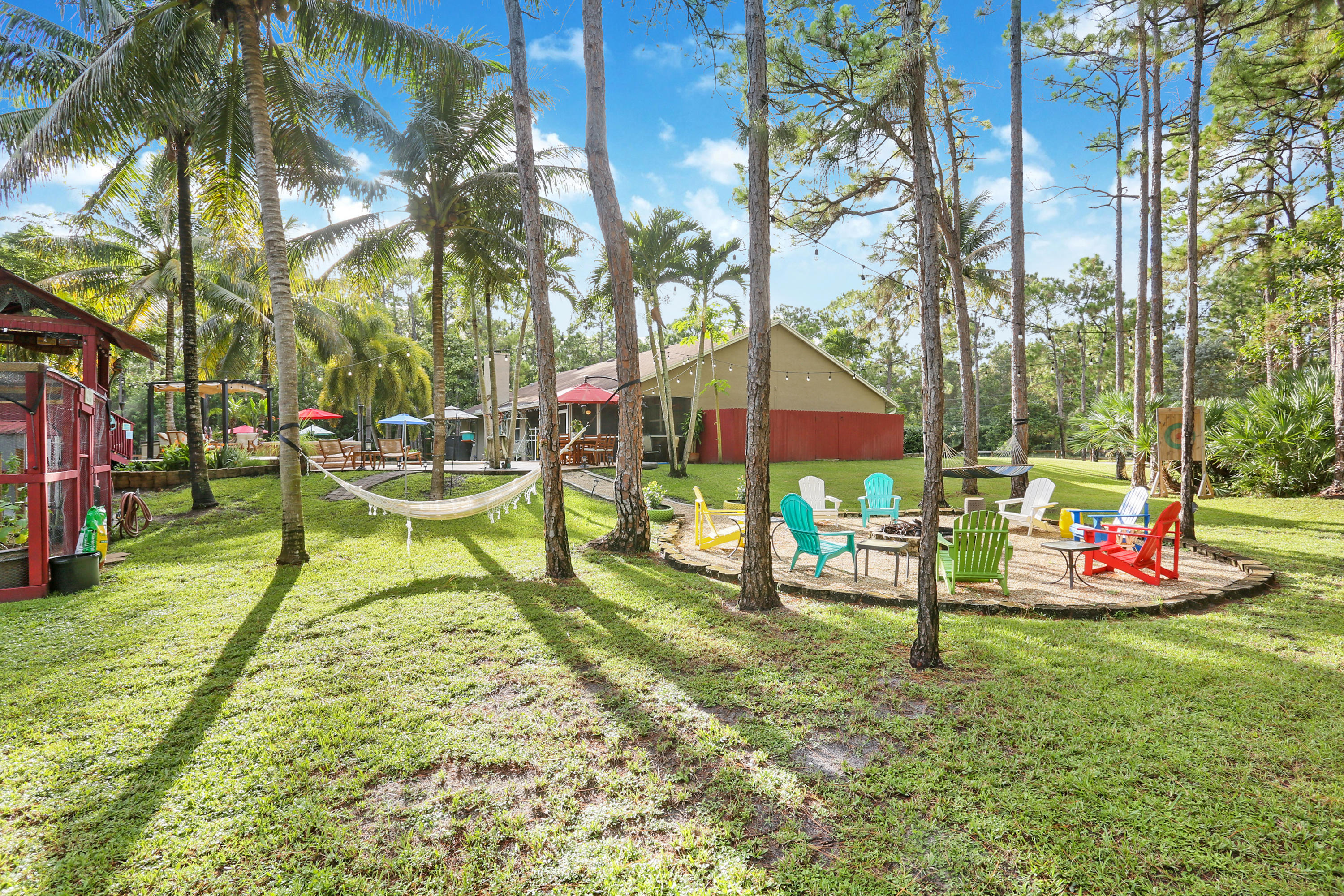 18604 43rd Road North Loxahatchee, FL 33470 - Photo 9 of 40 a backyard of a house with table and chairs