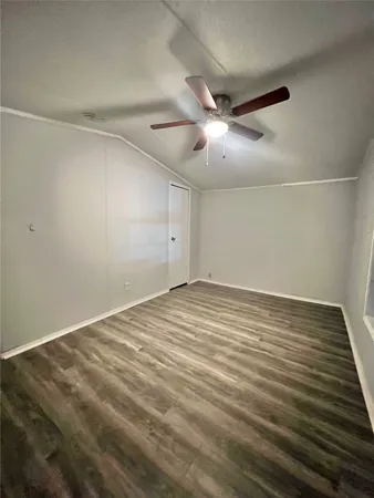 a view of an empty room with a chandelier fan