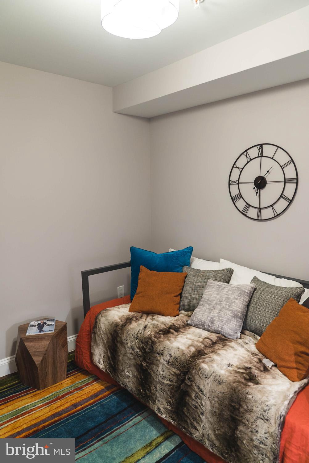 1823 D Street Northeast, Unit B Washington, DC 20002 - Photo 13 of 27 a bedroom with a bed and painting on the wall