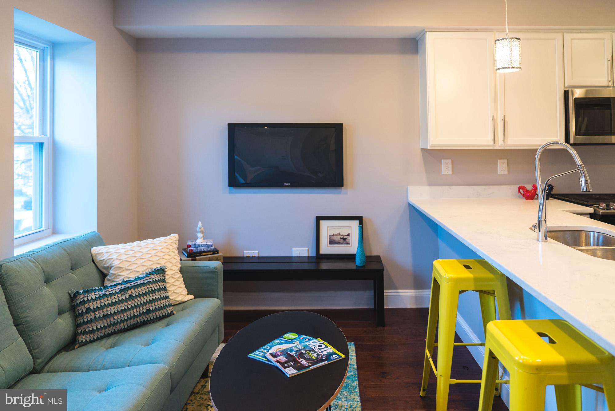 1823 D Street Northeast, Unit B Washington, DC 20002 - Photo 3 of 27 a living room with furniture and a flat screen tv