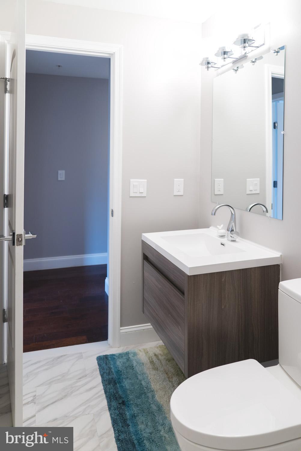 1823 D Street Northeast, Unit B Washington, DC 20002 - Photo 22 of 27 a bathroom with a sink a toilet and shower