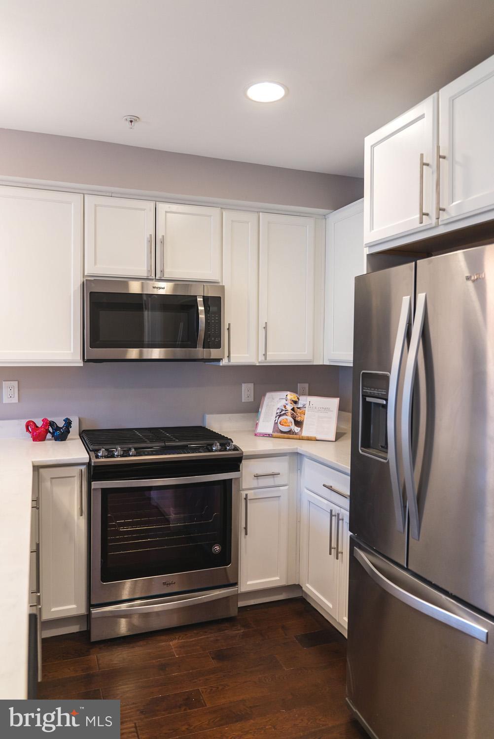 1823 D Street Northeast, Unit B Washington, DC 20002 - Photo 6 of 27 a kitchen with granite countertop a refrigerator stove and microwave