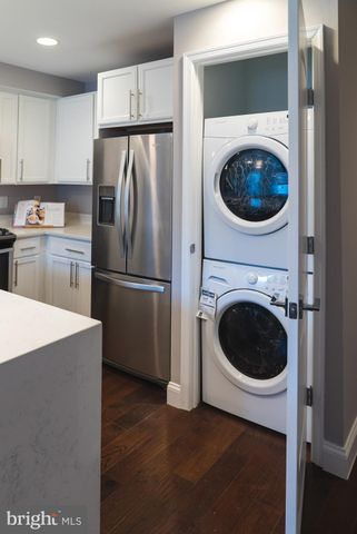 a kitchen with a refrigerator and a washer