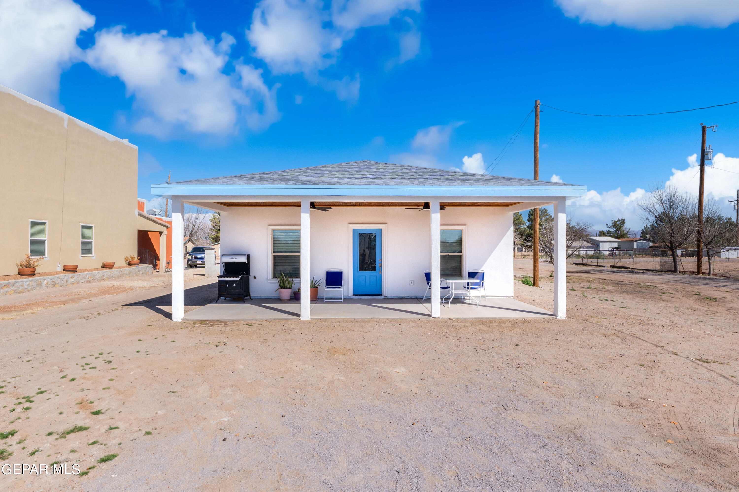 a view of a house with a patio and a yard